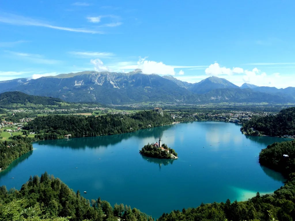 Lake Bled, Slovenia travel destination - scenic view of Pletna Boat to Bled Island at Dawn during ideal visiting season