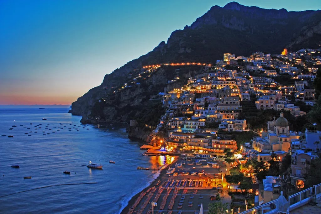 Positano, Italy travel destination - scenic view of Sunrise Serenity on Spiaggia Grande during ideal visiting season