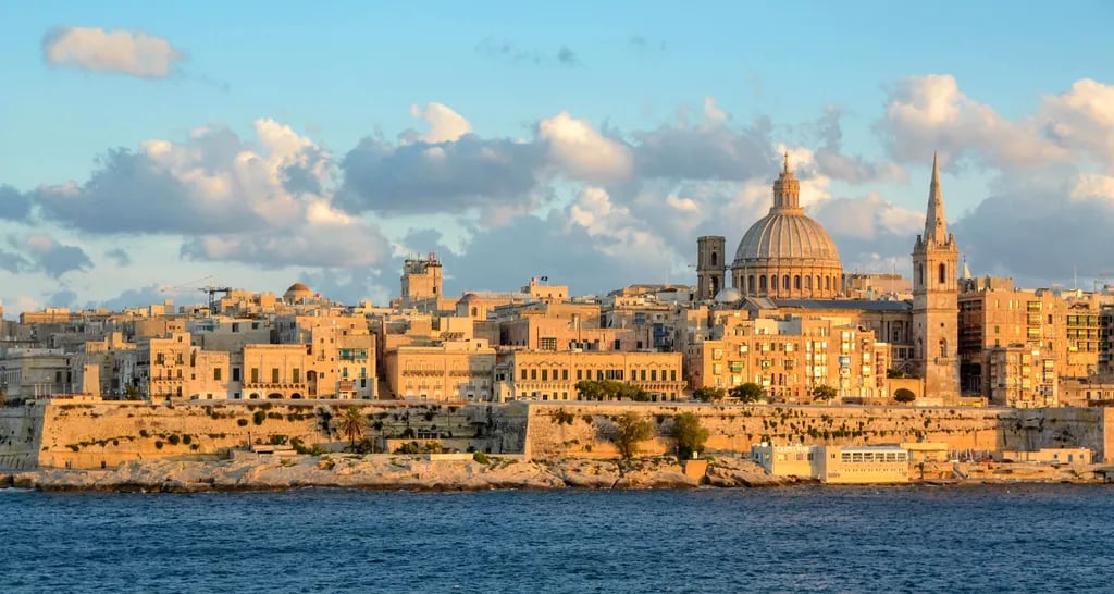 Valletta, Malta travel destination - scenic view of Sunrise over the Grand Harbour from Fort St. Angelo during ideal visiting season